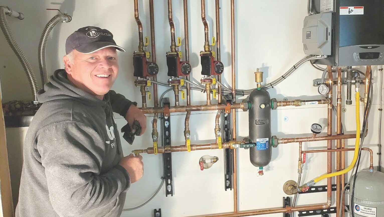 man installing a manifold for heating system